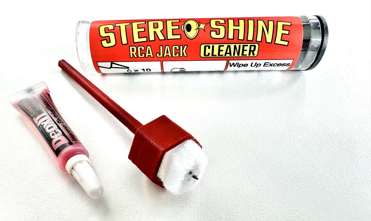 Picture of RCA Jack Cleaner tool, sachet of DeoxIT D100 cleaner and the packaging